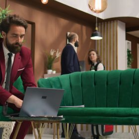 Business assistant reads papers on laptop, preparing to meet with partners at international conference in hotel. White collar worker improving speech notes for executive board presentation.